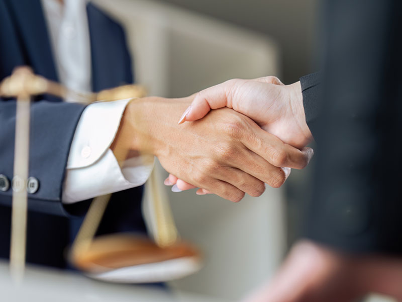 successful lawyer shaking hands with a client